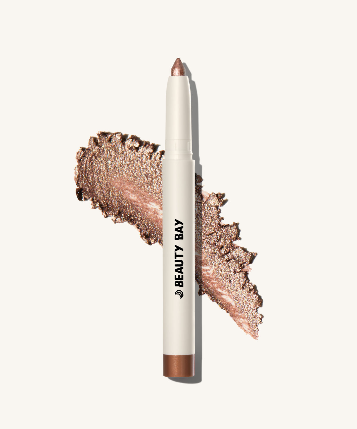 Shimmery Eyeshadow stick layout on top of the product swatch showing glittery bronze product