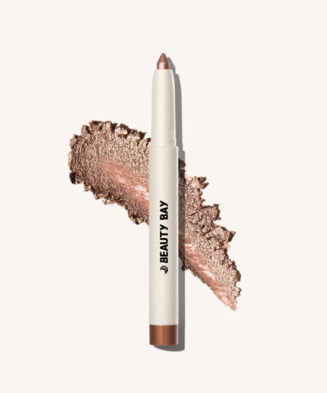 Shimmery Eyeshadow stick layout on top of the product swatch showing glittery bronze product